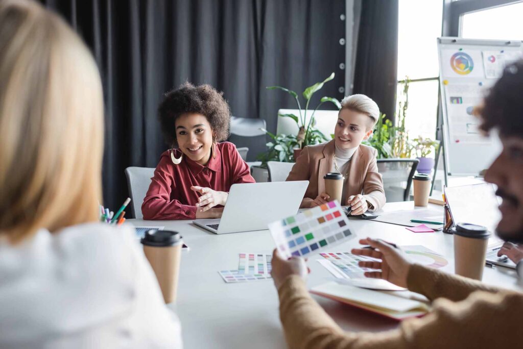 Designer and clients around a table discussing feedback